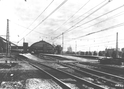 886038 Gezicht op de sporen en de perrons aan de westzijde van Amsterdam C.S.